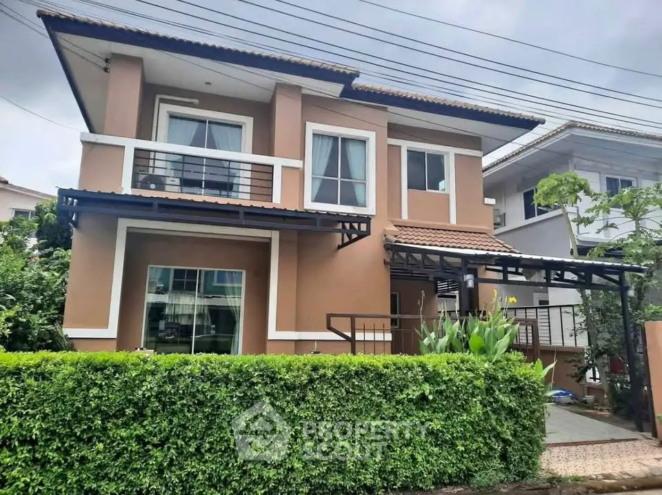 Charming two-story house with lush greenery and modern design in a serene neighborhood.