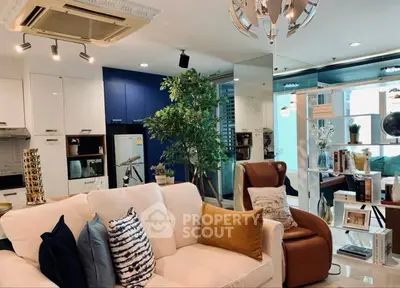 Luxurious modern living room with stylish decor and open layout, featuring plush seating and elegant lighting.