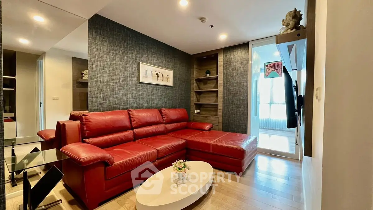 Modern living room with red leather sectional and stylish decor