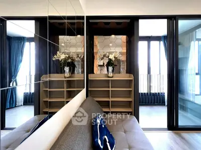 Modern living room with stylish decor and mirrored wall panels