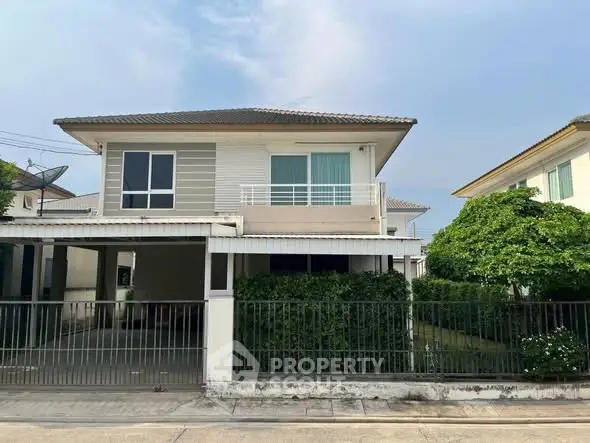 Charming two-story house with a modern facade and lush greenery in a serene neighborhood.