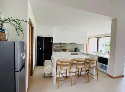 Modern kitchen with sleek white cabinets and breakfast bar in a bright open layout