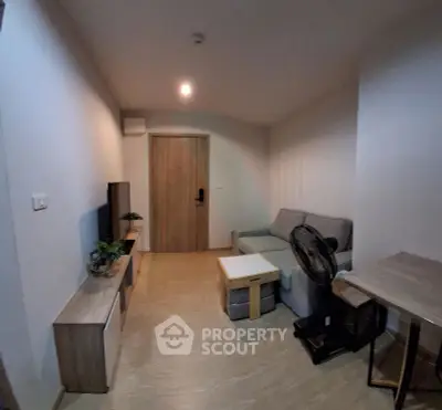Cozy modern living room with stylish furniture and wooden flooring, perfect for relaxation and entertainment.