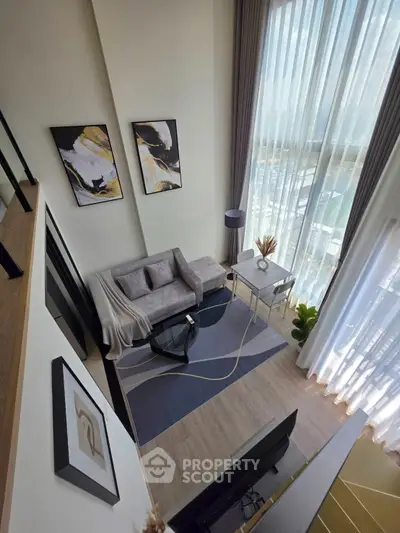 Modern living room with stylish decor and large windows