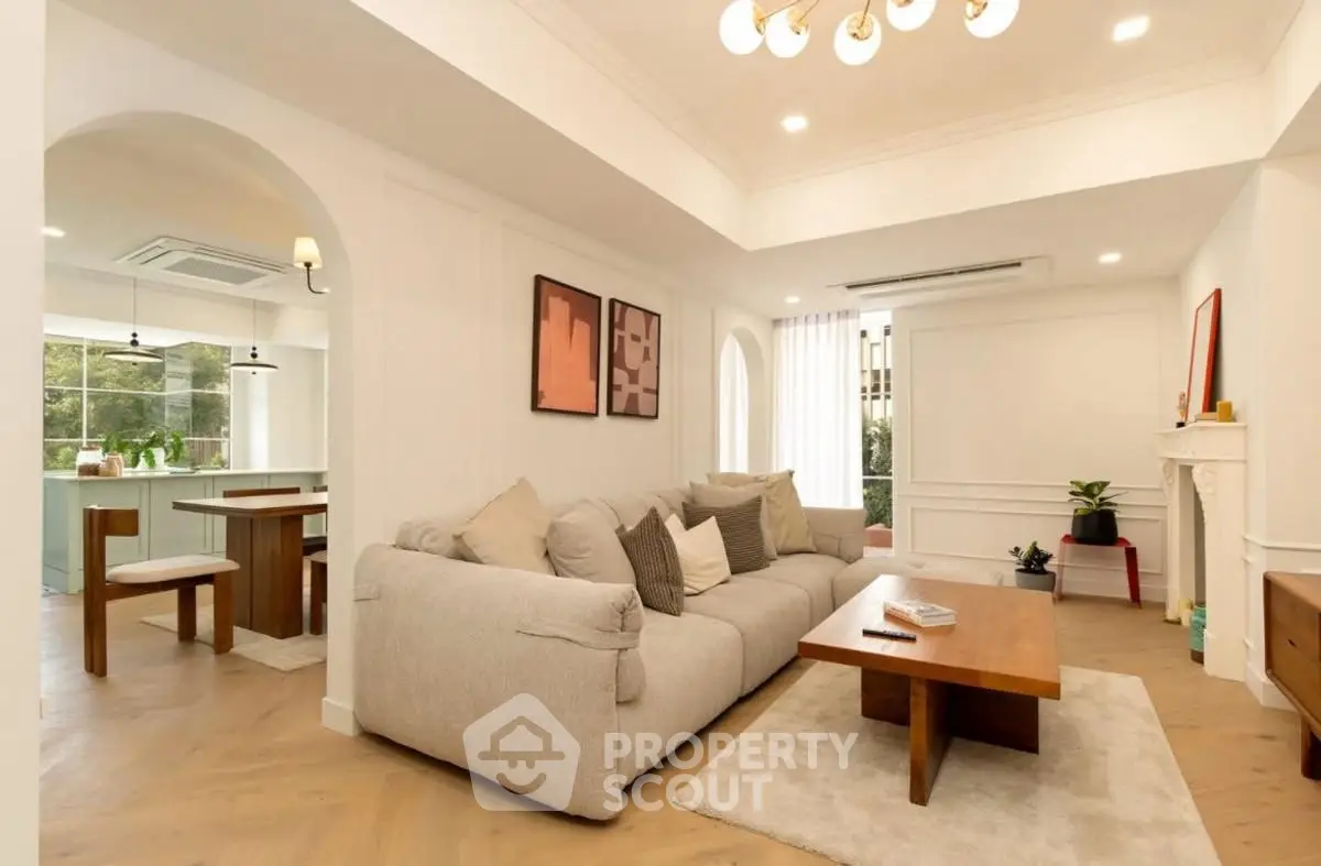 Spacious modern living room with elegant decor and open kitchen view