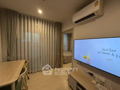 Modern living room with air conditioning and stylish dining area in a cozy apartment.