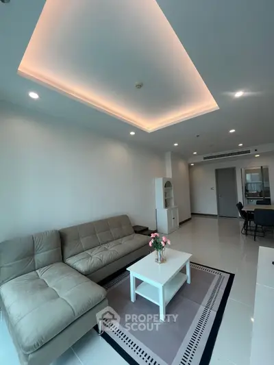 Spacious modern living room with elegant lighting and cozy seating area.