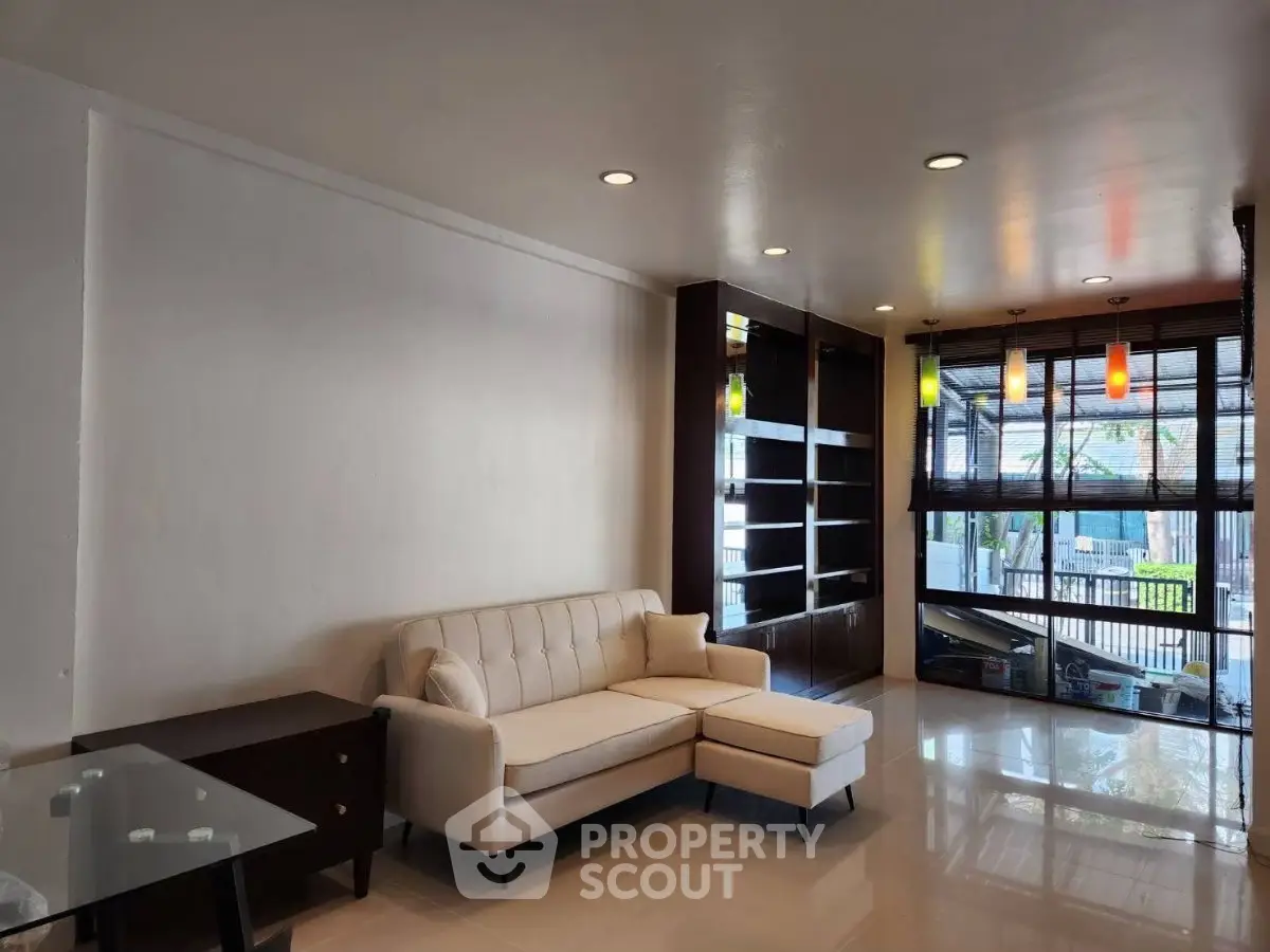Spacious living room with modern decor and large windows offering natural light.