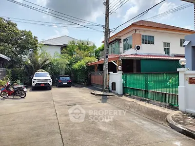 Charming suburban house with spacious driveway and lush greenery, perfect for family living.