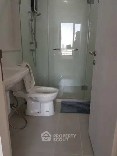 Modern bathroom with glass shower and sleek fixtures