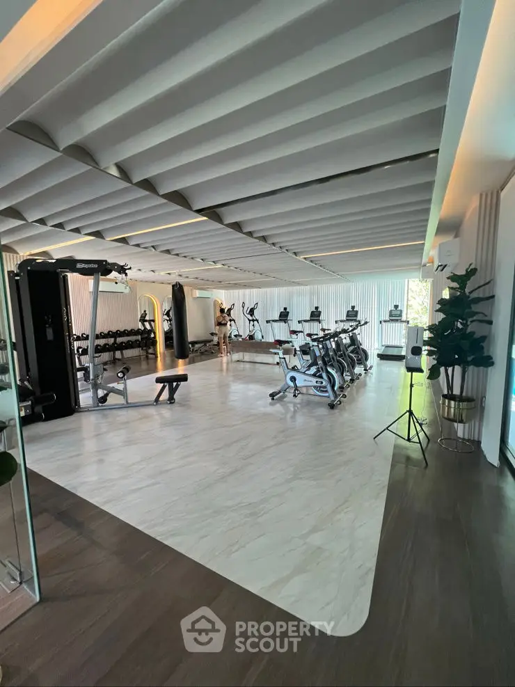 Luxurious gym with modern equipment and stylish design in upscale real estate property.