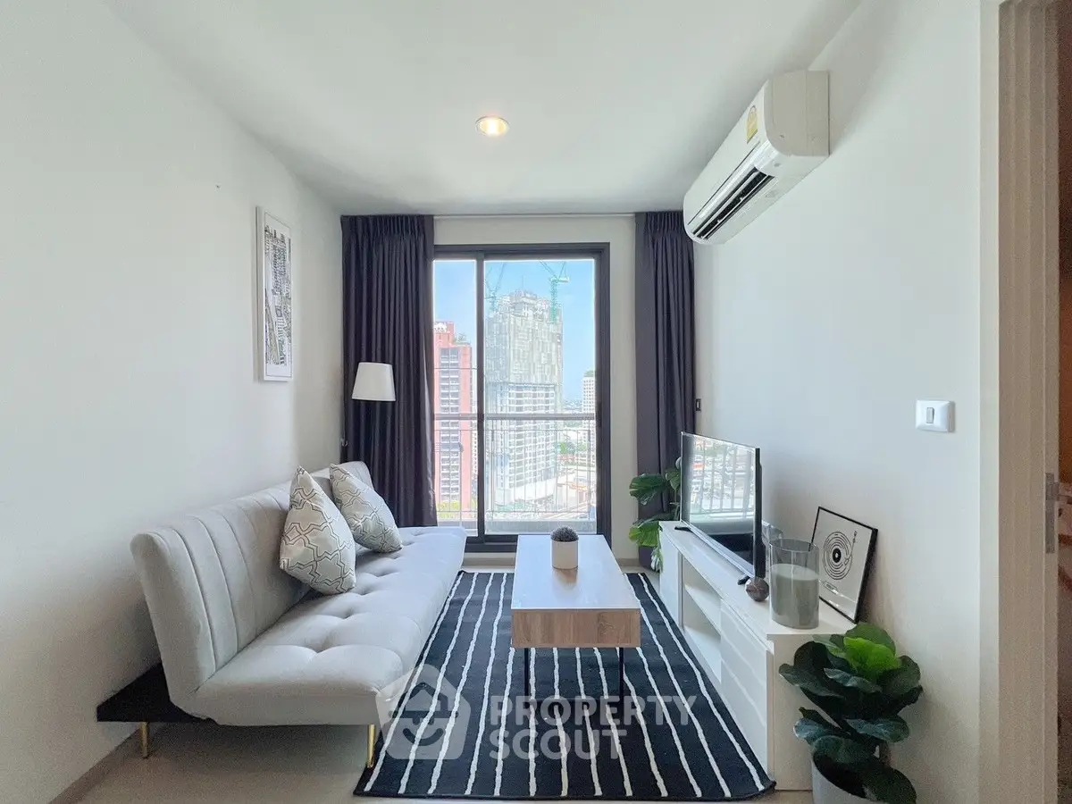 Modern living room with city view, stylish decor, and natural light.