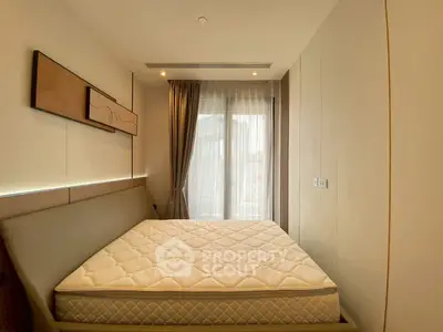 Modern bedroom with large window and stylish decor, featuring a comfortable bed and elegant lighting.