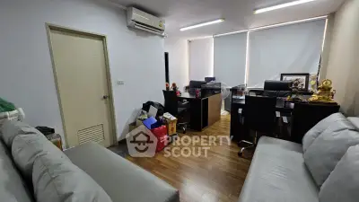 Spacious office room with modern furniture and ample natural light