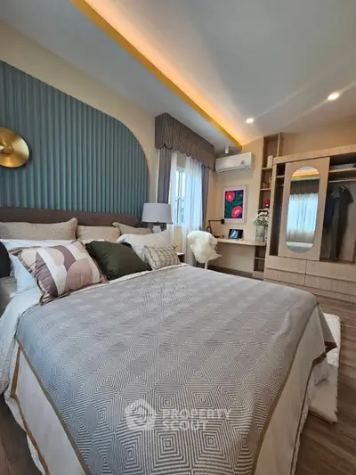 Luxurious bedroom with elegant decor and ample natural light, featuring a stylish bed and modern wardrobe.