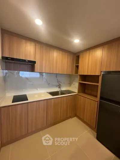 Modern kitchen with sleek wooden cabinets and integrated appliances