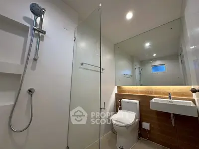 Modern bathroom with glass shower and sleek fixtures