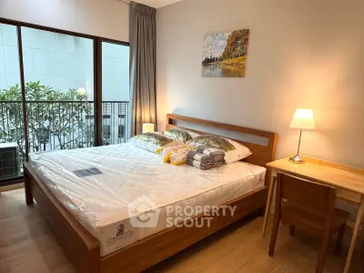 Cozy bedroom with wooden furniture and balcony view in modern apartment