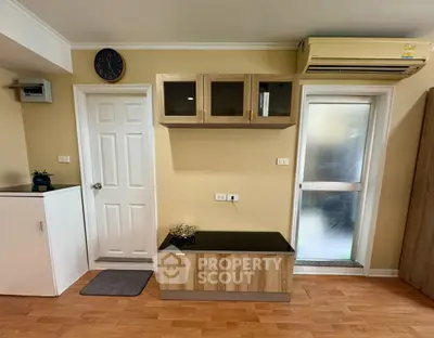 Modern interior with wooden cabinetry and air conditioning in a cozy living space.