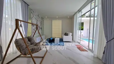 Luxurious living room with modern decor and pool view, featuring elegant marble accents and cozy seating.