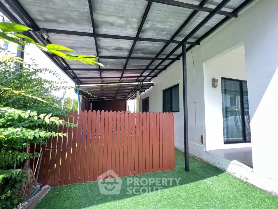 Charming outdoor space with covered patio and lush greenery, perfect for relaxation and entertaining.