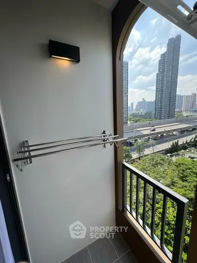 Modern balcony with city view and sleek railing in high-rise apartment