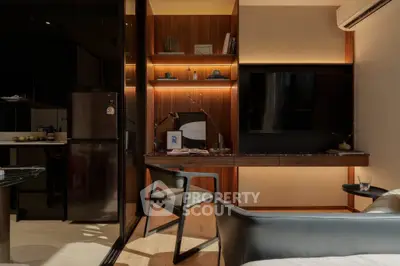 Modern study area with sleek desk, stylish chair, and ambient lighting in a contemporary apartment.