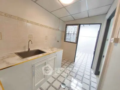 Bright kitchen with tiled floor and marble countertop in modern home
