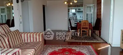 Spacious living room with elegant dining area and modern kitchen in open layout.