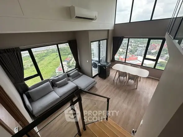 Stunning high-rise living room with panoramic city views and modern furnishings.