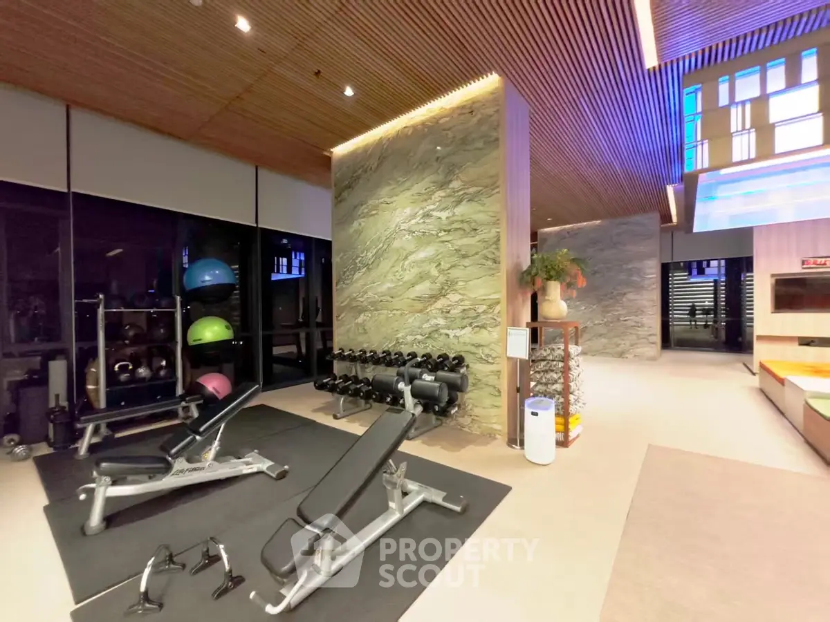 Luxurious gym with modern equipment and stylish decor in upscale real estate property.