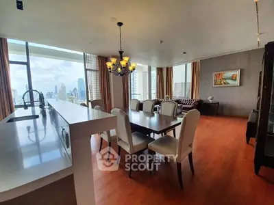 Luxurious open-plan living and dining area with city views and elegant decor.