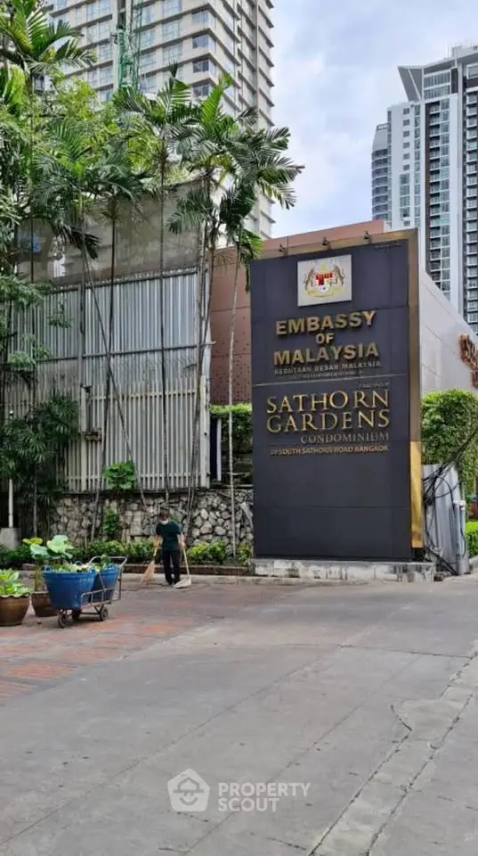 Sathorn Gardens Condominium entrance with lush greenery and modern architecture in Bangkok.