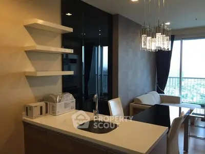 Modern open-layout kitchen and living area with city view balcony.