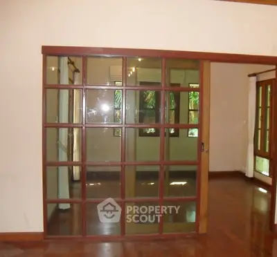 Spacious living room with elegant wooden sliding doors and polished hardwood floors.