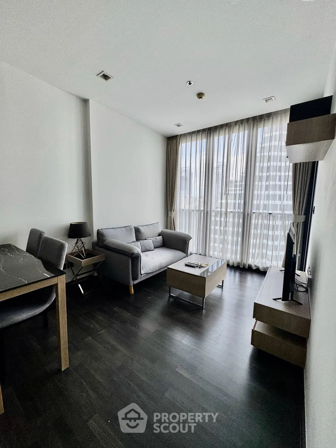 Modern living room with sleek furniture and large window view