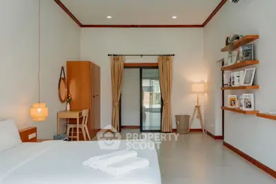 Spacious bedroom with modern decor and natural light