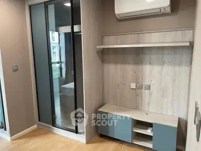 Modern bedroom with sleek built-in wardrobe and air conditioning unit, perfect for urban living.