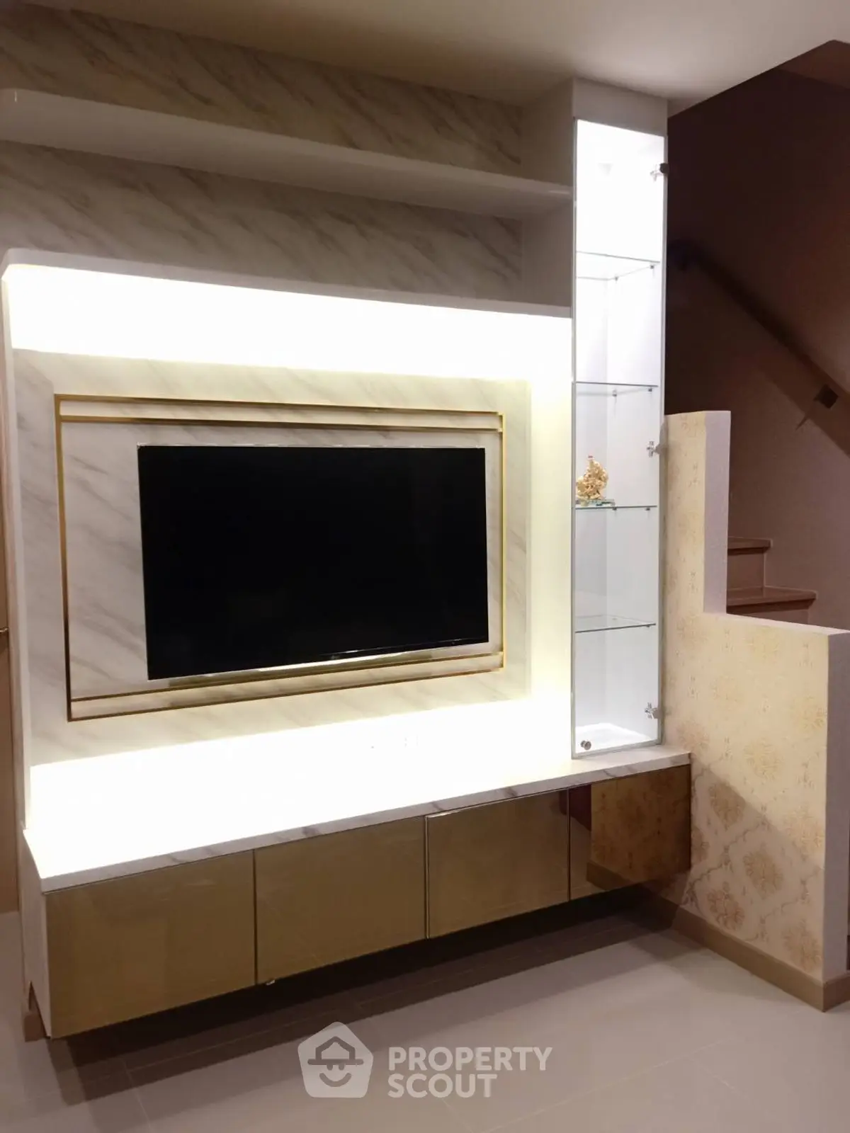 Modern living room with sleek TV unit and elegant lighting