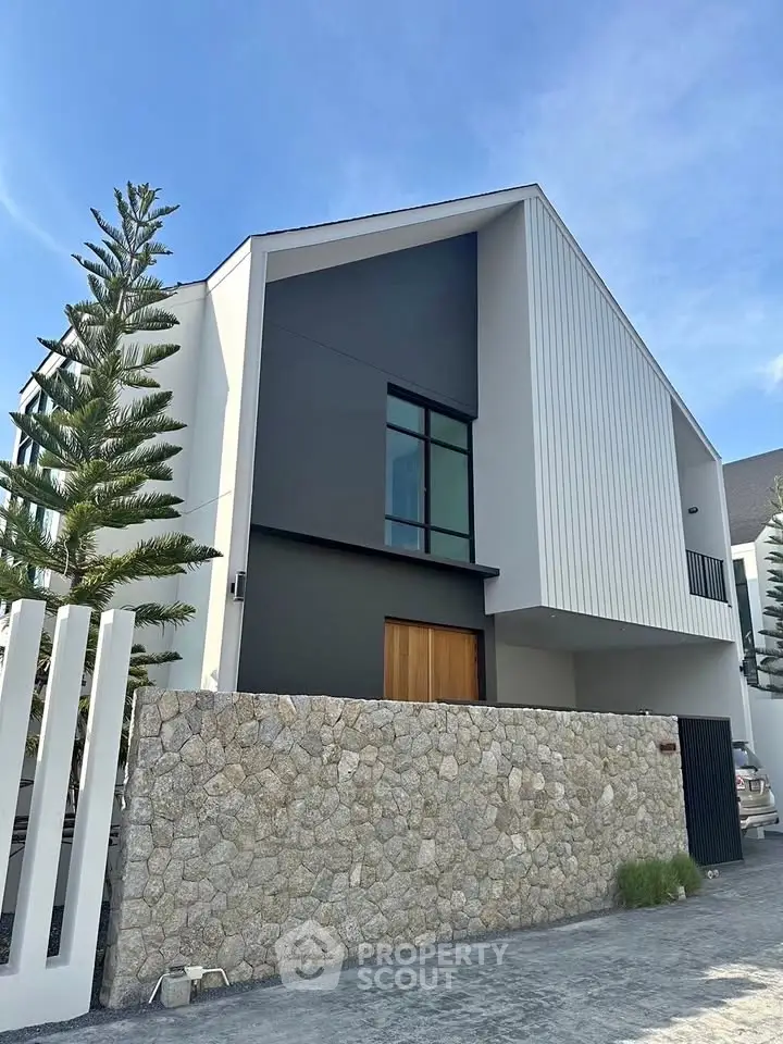 Modern architectural home exterior with sleek design and stone wall facade