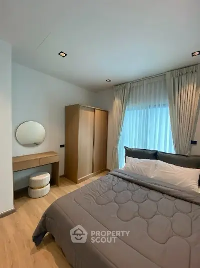 Modern bedroom with stylish decor and natural light