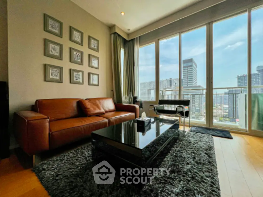 Modern living room with leather sofa and city view from large windows.