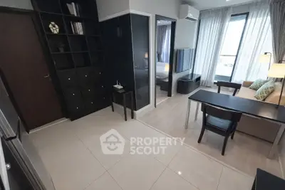 Modern studio apartment with sleek design, featuring a cozy living area and a separate bedroom space.