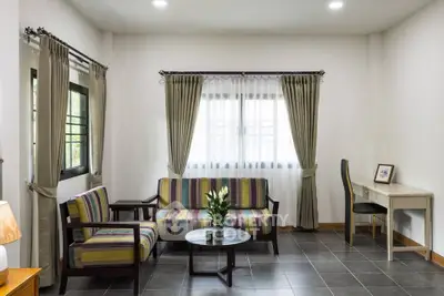 Stylish living room with modern furniture and natural light, perfect for relaxation and entertaining.