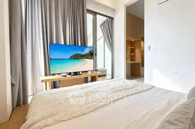 Luxurious bedroom with modern decor and stunning view from balcony