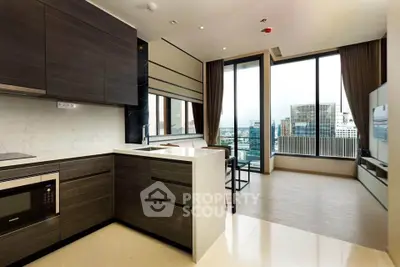 Modern open-layout kitchen with sleek cabinetry and city view from large windows.