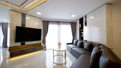 Luxurious modern living room with sleek design and large TV