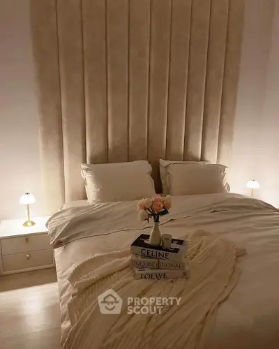 Luxurious bedroom with elegant decor and soft lighting, featuring a cozy bed and stylish side tables.