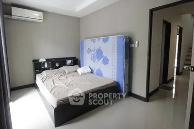 Spacious bedroom with modern decor and air conditioning unit, perfect for comfort and relaxation.