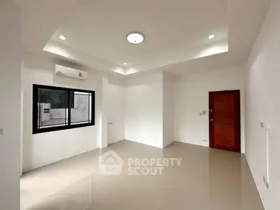 Spacious unfurnished room with modern lighting and air conditioning, perfect for customization.